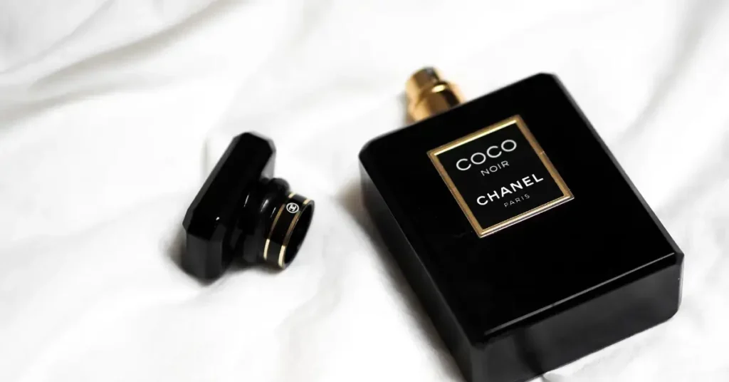 Chanel coco noir, a black perfume bottle on a blanket