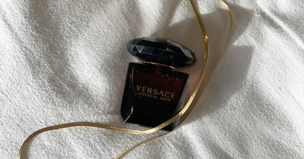 Versace Purple Perfume named Crystal Noir on a blanket