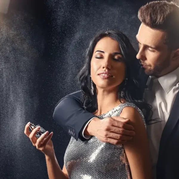 Woman and Man spraying a top rated pheromone perfume around them
